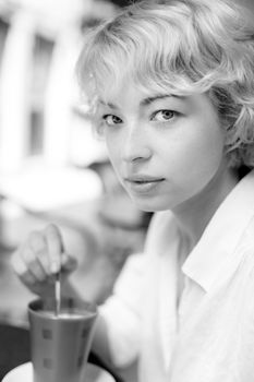 Casual Dressed Beauty Girl With Cup of Coffee in black and white.