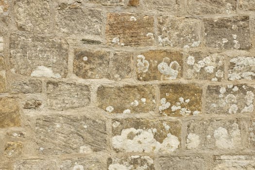 A cut sandstone wall with traditional lime mortar pointing.