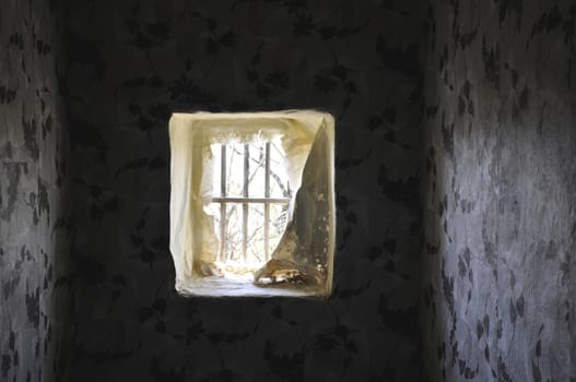 On the inside of the window in the old vacated house