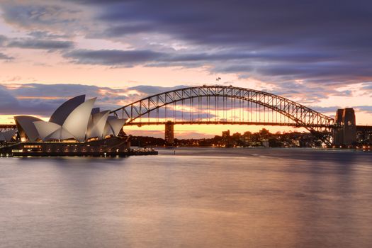 SYDNEY, AUSTRALIA - JULY 12, 2014;  Sydney Harbour Bridge and Sydney Opera House at sunset.  Long exposure.