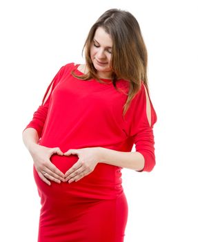 beautiful pregnant woman holding hands in heart shape