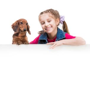 smilling little girl and dog breed dachshund with a whiteboard for your text