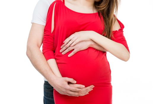 husband hugging his pregnant wife on a white background