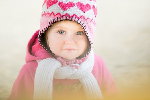 portrait of a smiling little girl outdoors
