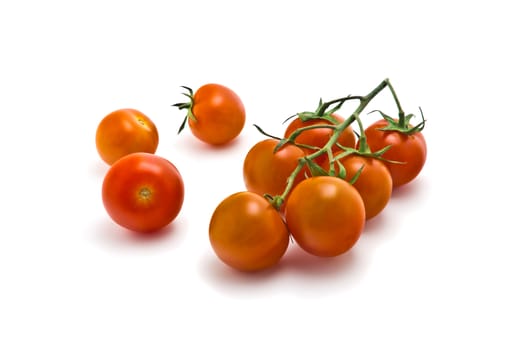 sprig of of ripe, juicy cherry tomatoes on a white background