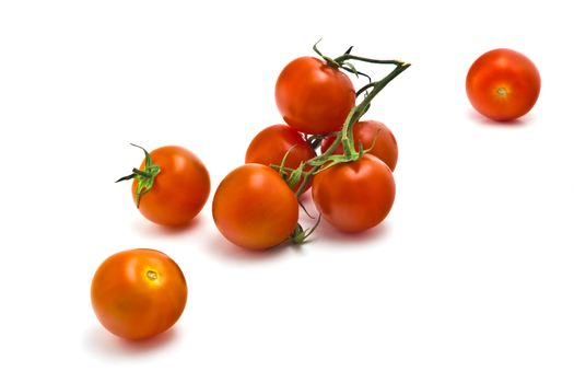 sprig of of ripe, juicy cherry tomatoes on a white background