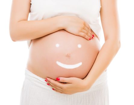 Cream happy smiley face on the belly of pregnant woman isolated on white