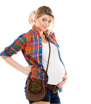 Beautiful pregnant white woman wearing shirt with hands on belly isolated on a white background