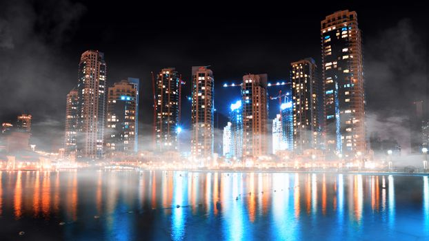 Dubai downtown night scene with city lights and fog