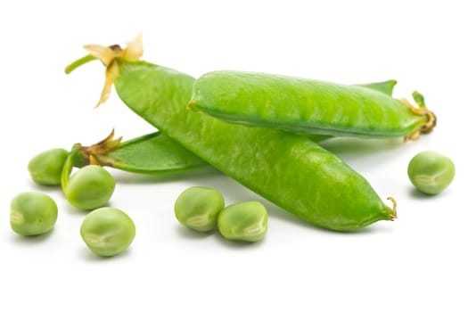 pods of green peas and some peas on a white background
