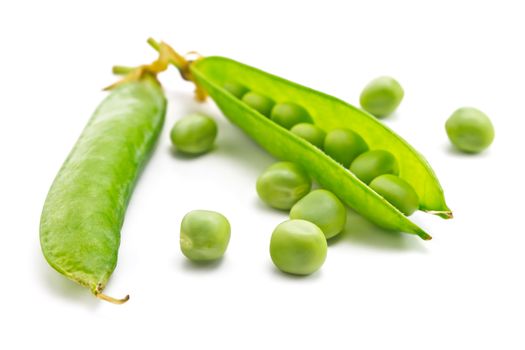 pods of green peas and some peas on a white background