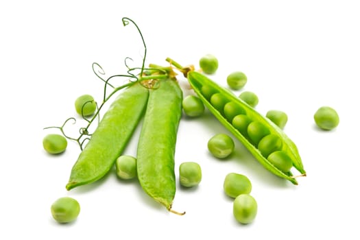 pods of green peas and some peas on a white background