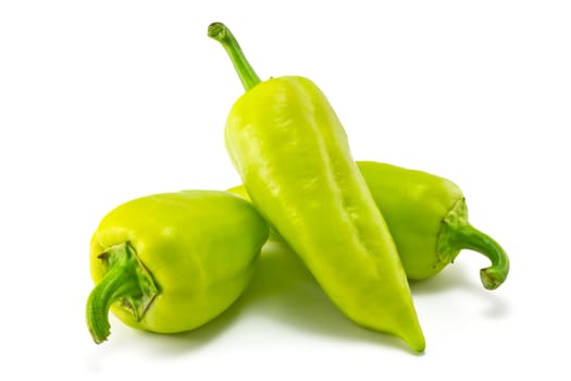 green sweet peppers on a white background