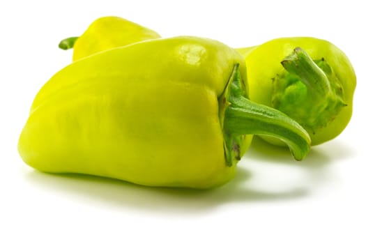 green sweet peppers on a white background