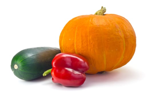 ripe pumpkin, zucchini and a sweet pepper isolated on white background