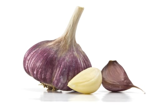 heads of garlic and garlic cloves on a white background