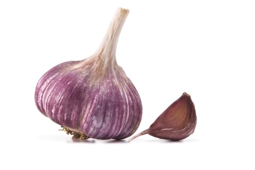 heads of garlic and garlic cloves on a white background