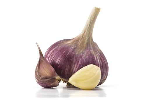 heads of garlic and garlic cloves on a white background