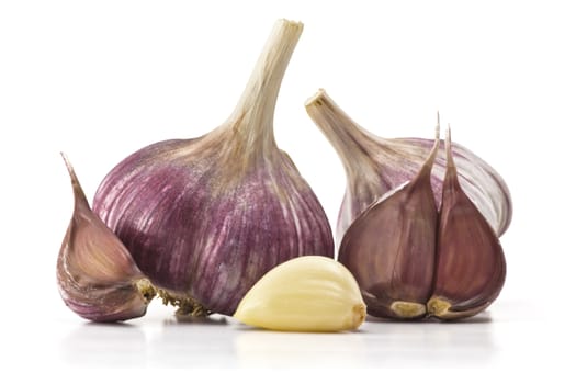 heads of garlic and garlic cloves on a white background