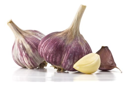 heads of garlic and garlic cloves on a white background