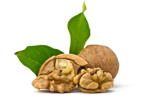 two walnuts, of kernels belonging and leaves on a white background