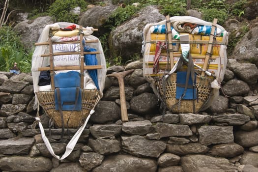 Packs carried by porters lined up against a wall in the Himalaya Mountains, Nepal.