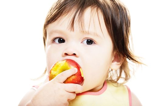 Young girl biting into red apple