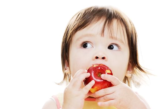 Young girl enjoying a fresh red apple