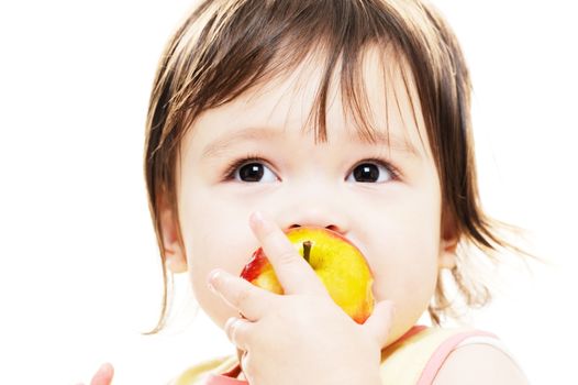 Young girl biting into fresh apple