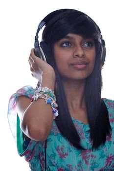 A teen girl listening to music on headphones