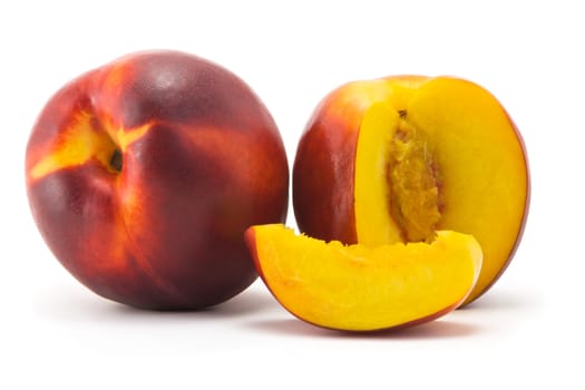 Two ripe juicy nectarine and cut portion on a white background