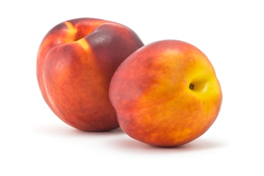 two juicy ripe nectarine on a white background