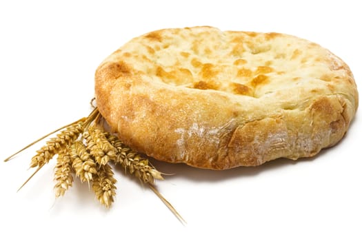 crispy pita bread and spikelets wheat on a white background