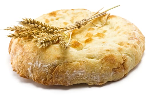 crispy pita bread and spikelets wheat on a white background