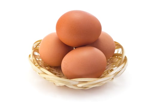 boiled eggs in a straw wall outlet isolated on white background