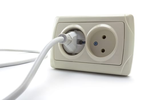 double socket and the cord with a plug on a white background