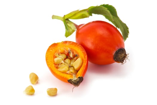 eglantine with half of fruit and seeds isolated on white background