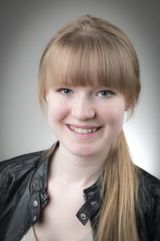 Portrait of a blond girl with black leather jacket