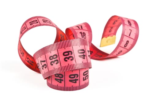 pink tape measure twisted spiral on white background