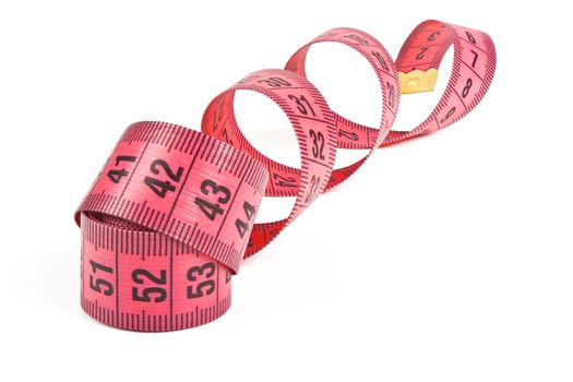 pink tape measure twisted spiral on white background