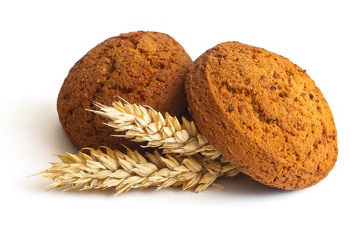 Oatmeal cookies and spikelets on white background