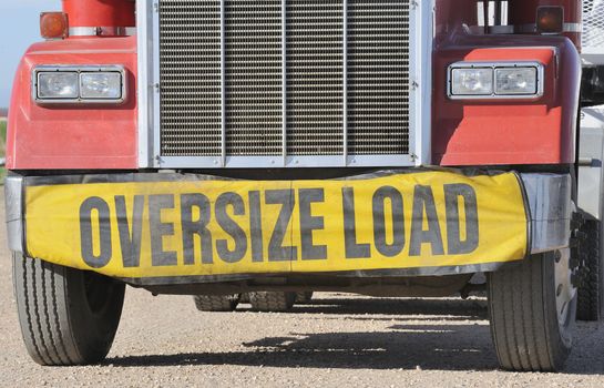 Closeup of oversize load sign on front of haulage truck