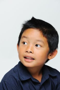 Cute asian boy looking away and smiling