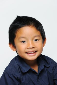 Asian boy looking happy wearing blue shirt