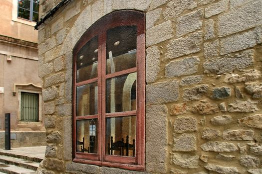 Window painted on old wall. Old city in Kotor