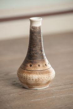 Traditional handcrafted vase of brown color on the table