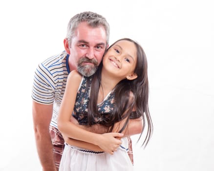 Caucasian father holding mixed race daughter, happy and smiling