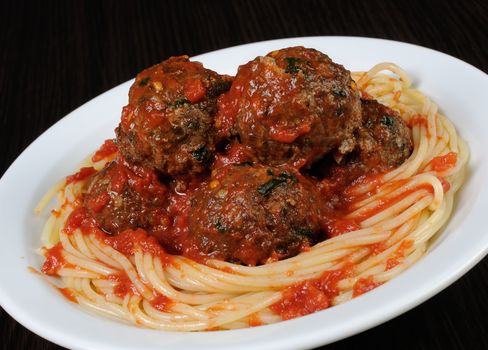 Meatballs with herbs and tomato sauce with spaghetti
