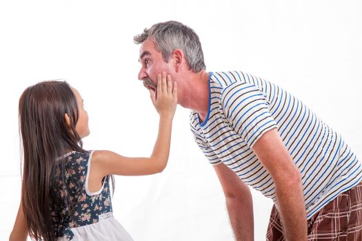 Female child slapping father across face, dad shocked
