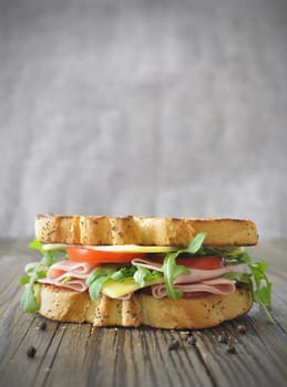 Ham and cheese sandwich with toasted bread and rocket leaves with copyspace 